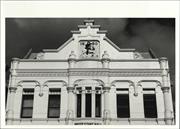 View of building façade showing plaque on pediment