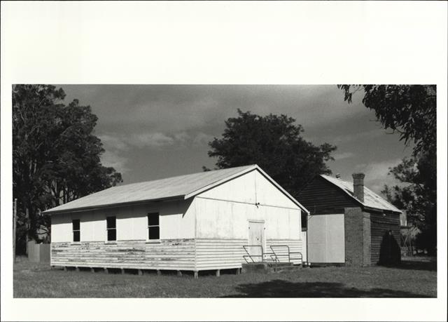 Corner elevation of later building showing original building in background