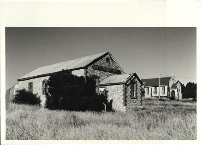 Corner elevation of Hall with church visible in the background