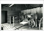 Interior view of stable showing carts