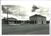 Front corner elevation, large antenna mast visible in background