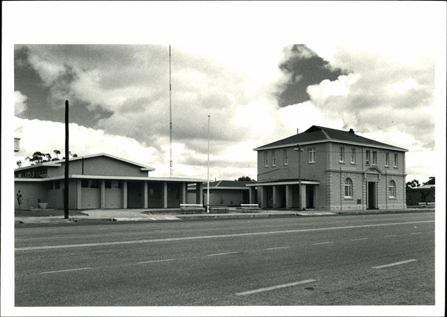 Front corner elevation, large antenna mast visible in background