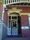 Front door with leadlights to door, sidelights and fanlights. Note original wall