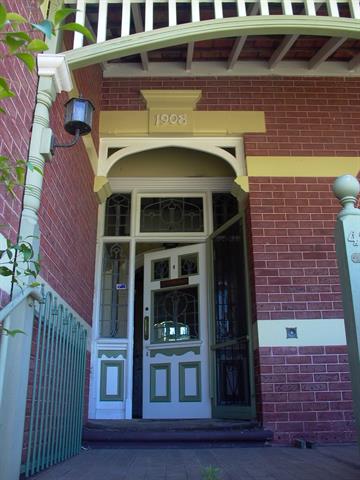 Front door with leadlights to door, sidelights and fanlights. Note original wall
