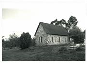 Rear corner elevation with graves in the right foreground
