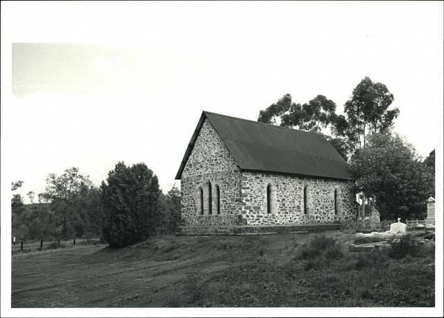 Rear corner elevation with graves in the right foreground