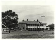 Distant front corner elevation of building