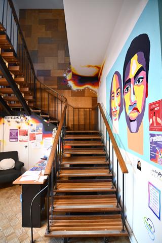 Original staircase with original timber veneer wall art behind