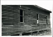 Side view of building showing deteriorating state of woodwork