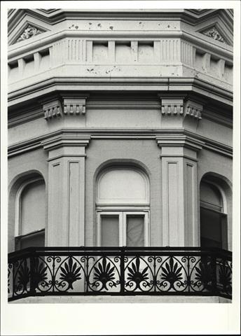 Detail of balcony ironwork, frieze and cornice